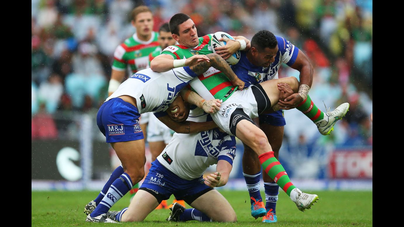 Joel Reddy of the South Sydney Rabbitohs is tackled by Canterbury Bulldogs during a National Rugby League match in Sydney on Friday, April 3.