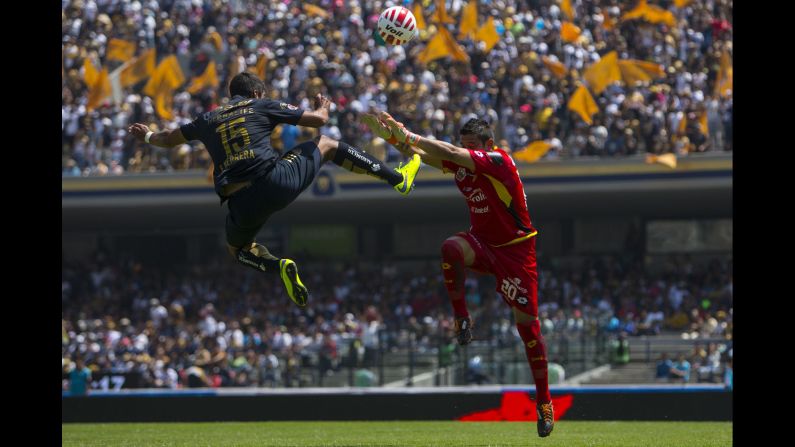 Eduardo Herrera of Pumas UNAM competes for the ball with Leones Negras goalkeeper Ivan Vazquez during a Liga MX match in Mexico City on Sunday, April 5.