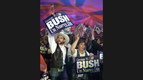 Hispanic supporters of Bush cheer and hold up a sign that reads "A New Day" in Spanish, after the Texas governor won the Republican Party's unofficial "straw poll" on August 14, 1999, in Ames, Iowa.