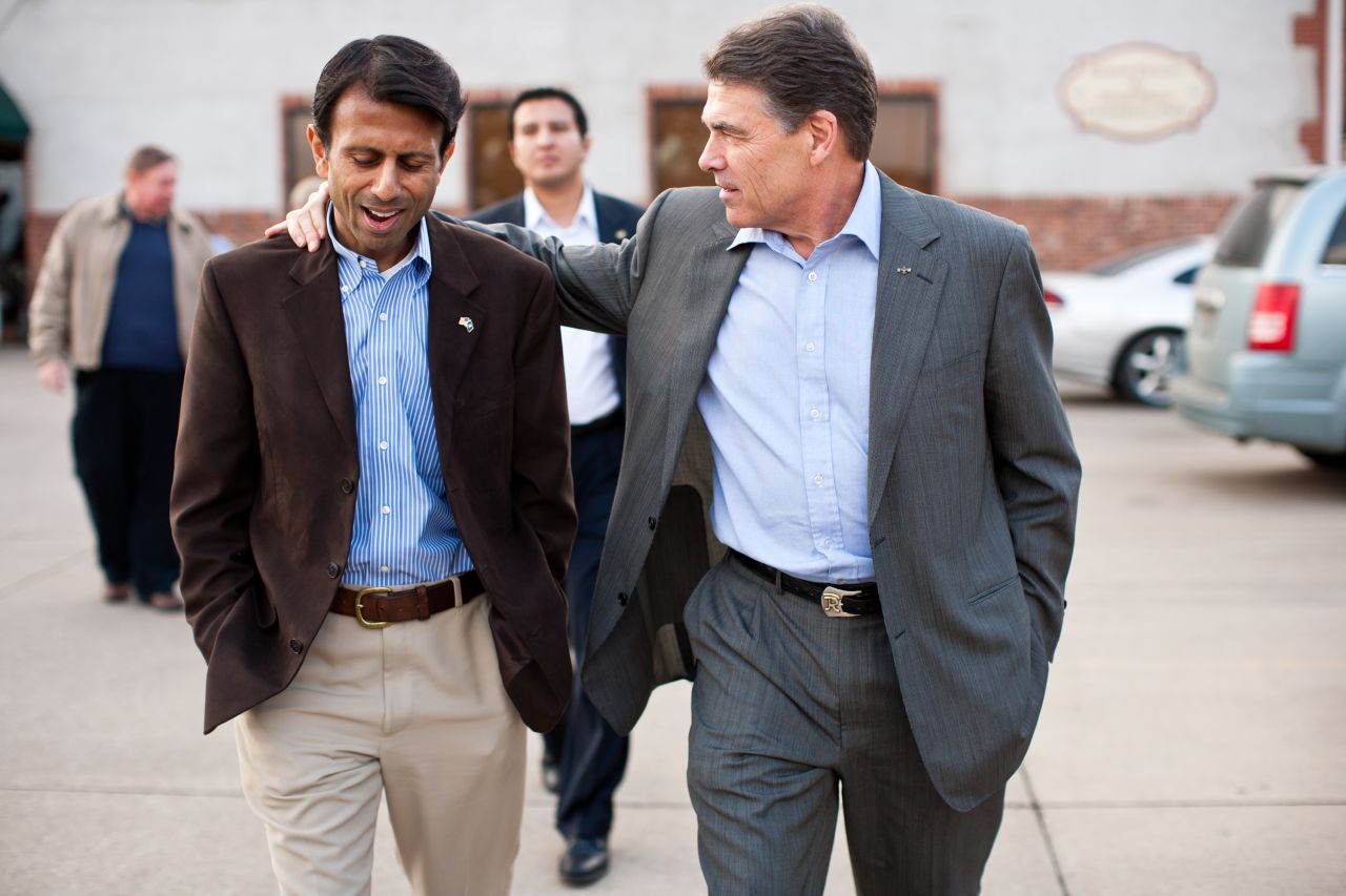Jindal and Texas Gov. Rick Perry walk together after a Perry presidential campaign meet-and-greet in Muscatine, Iowa, on December 21, 2011.
