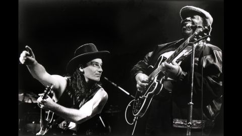 King and Bono of U2 perform in Rotterdam, Netherlands, in 1990. King recorded the song "When Love Comes to Town" with the band.