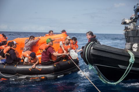 Sea Shepherd crew hand over water to the Thunder crew in life rafts.