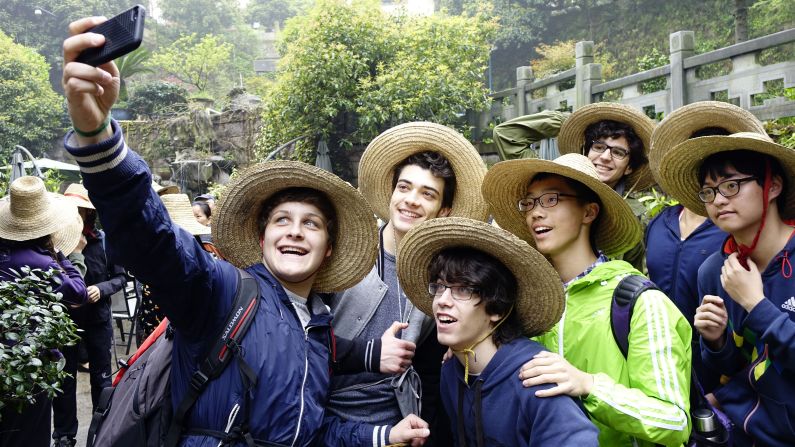 High school students take selfies as they visit a tea garden in Hangzhou, China, on Sunday, April 5. A group of Swiss students visited the garden with their Chinese peers to learn about the Longjing Tea culture.