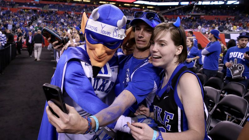 The mascot of the Duke Blue Devils poses with basketball fans before a Final Four game in Indianapolis on Saturday, April 4.