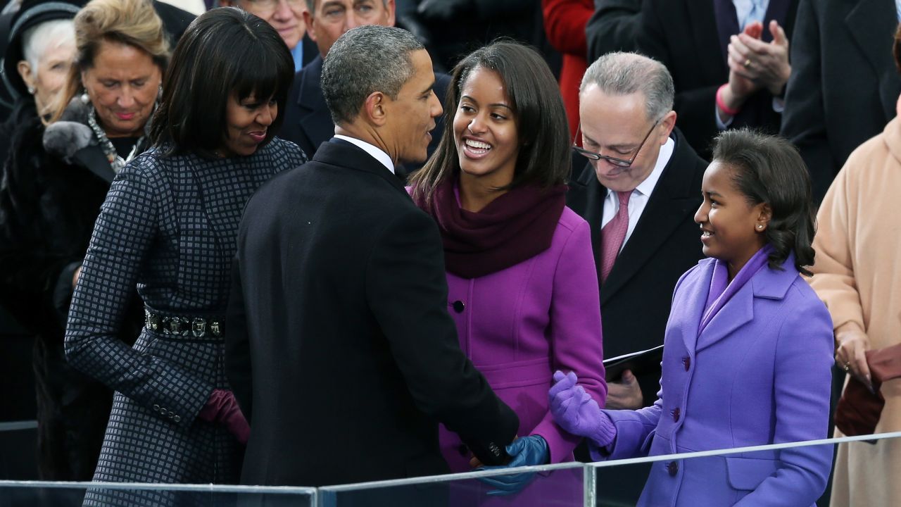 President Obama greets his wife and daughters after being sworn in for his second term in January 2013.