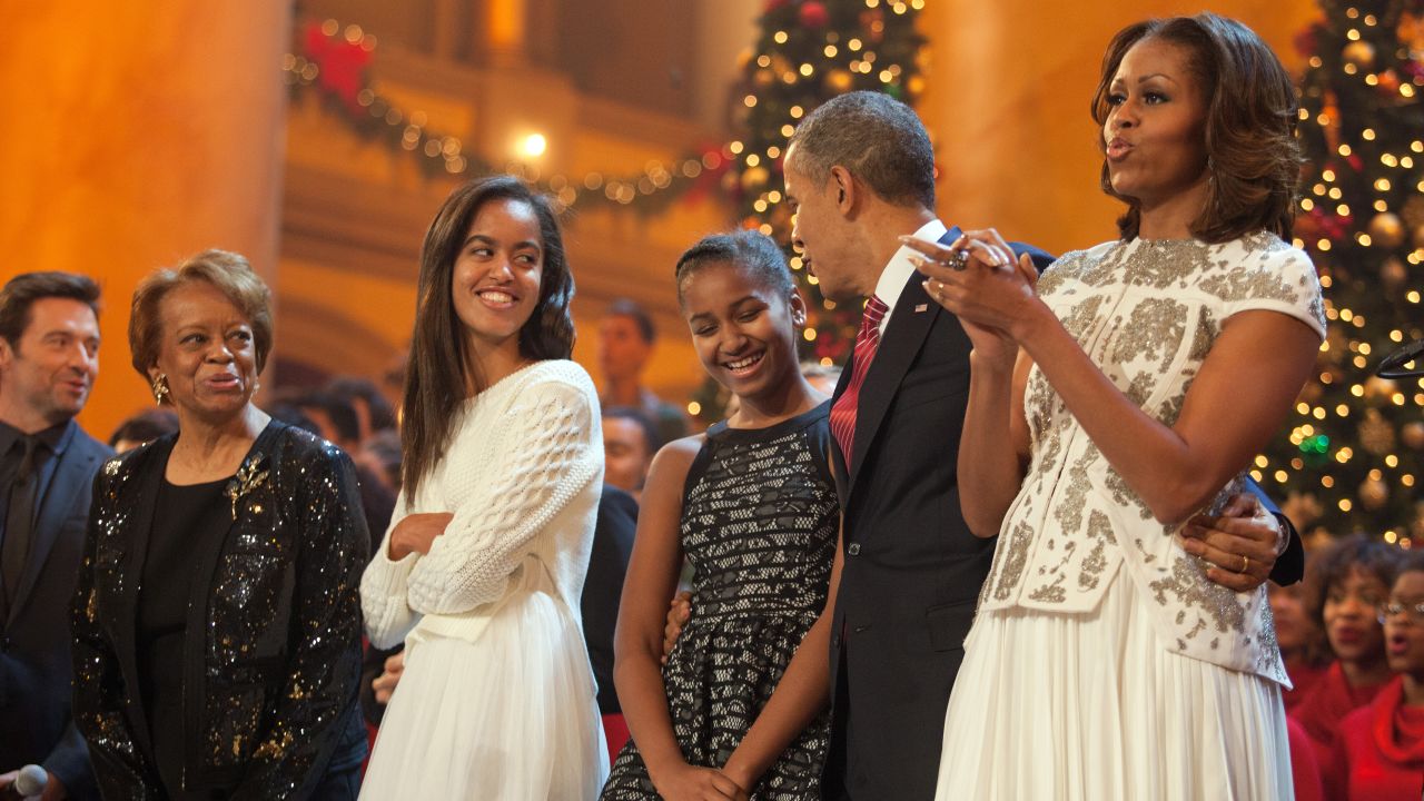 The first family sings during the finale of TNT's "Christmas in Washington" program in December 2013. Michelle Obama's mother, Marian Robinson, and the program's host, actor Hugh Jackman, are at left. Time Warner is the parent company of TNT and CNN.