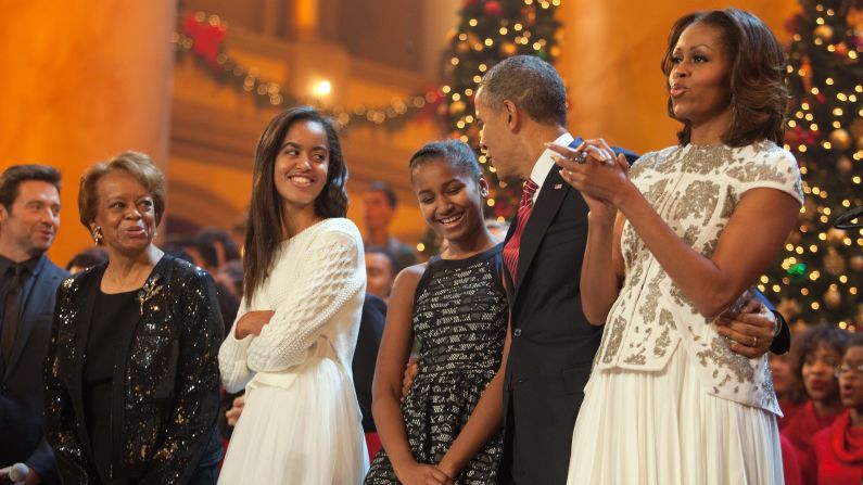 The first family sings during the finale of TNT's "Christmas in Washington" program in December 2013. Michelle Obama's mother, Marian Robinson, and the program's host, actor Hugh Jackman, are at left. Time Warner is the parent company of TNT and CNN.
