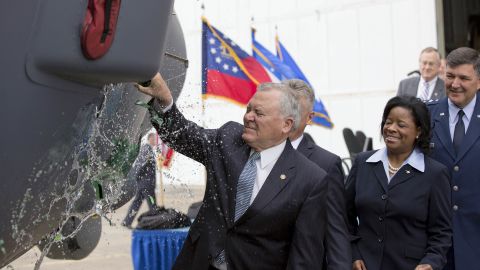 During a christening ceremony, Georgia Gov. Nathan Deal smashes a bottle of Chattahoochee River water across the nose of the MC-130J Super Hercules at the Lockheed Martin factory. Water was used instead of the traditional champagne in honor of former Gov. Marvin Griffin, a teetotaler who used river water to christen the first C-130 to come off the assembly line in 1955.