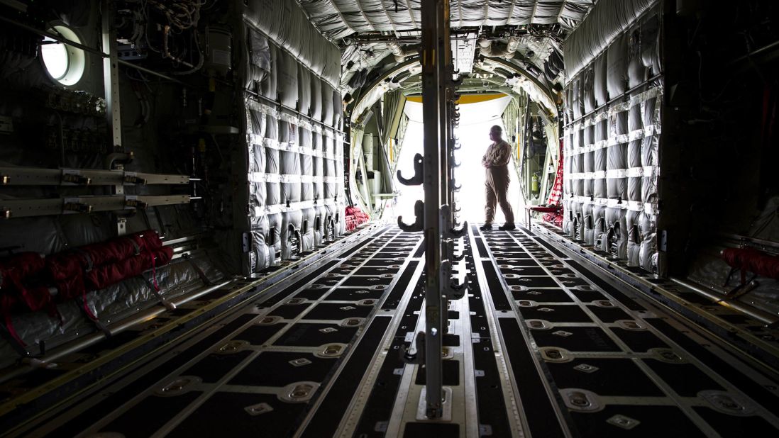 Lockheed loadmaster Lucky Madsen stands inside the cargo hold of the MC-130J. The floor can be quickly and easily converted from a flat surface to a floor embedded with rollers. The rollers allow cargo to be easily moved and unloaded from the plane.