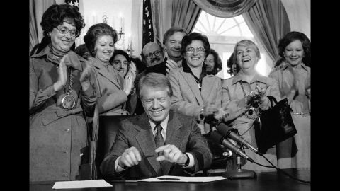Also in 1978, then-President Jimmy Carter signed legislation extending the original ERA ratification deadline from 1979 to 1982. Among those watching is his wife, Rosalynn, far right. Now 90, Carter says he is devoting the rest of his life to fighting for women's rights at the urging of the former first lady.