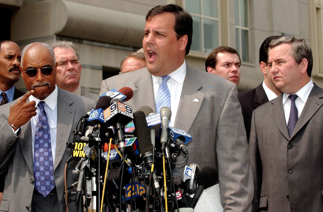 Christie speaks to the media about an FBI sting with Russian Gen. Sergei Fomenko, right, of the Federal Security Service and FBI Agent Louie Allen on August 13, 2003, in Newark, New Jersey.