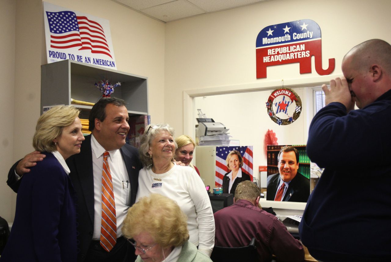 Christie and his running mate, Kim Guadagno, left, pose for photographs after making phone calls to voters at Monmouth County Republican Headquarters in Freehold, New Jersey, on November 2, 2009.
