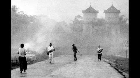 The aerial attack was intended for enemy forces on the outskirts of the village, but it accidentally hit South Vietnamese soldiers and civilians. Here, a man and woman carry injured children down the road following the bombing.