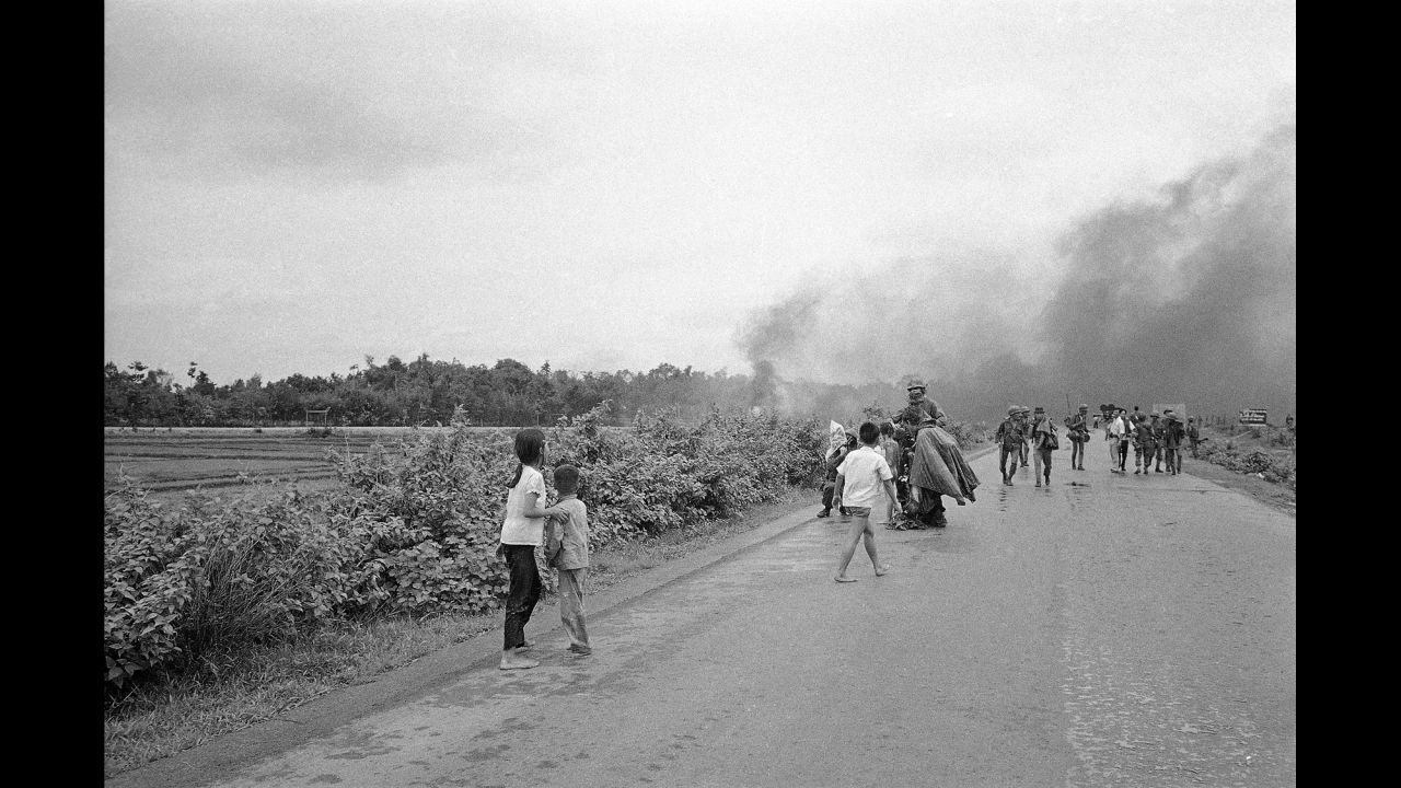Injured civilians and soldiers flee from the site of the attack.