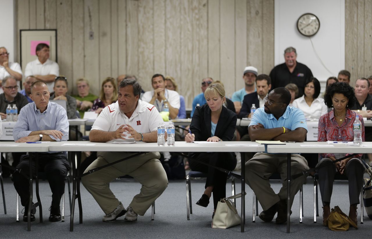 Christie talks to business owners affected by a massive fire that burned a large portion of the Seaside Park boardwalk, which had recently been rebuilt after Superstorm Sandy, on September 14, 2013, in Seaside Heights, New Jersey.