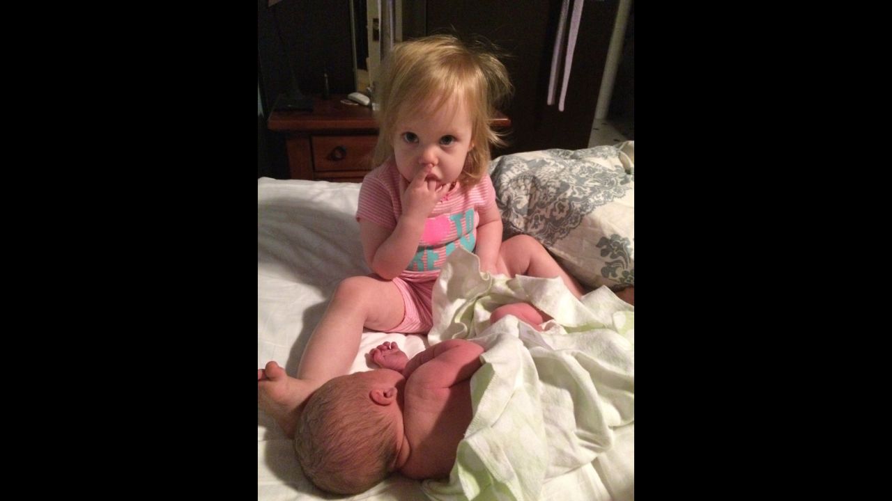 "My son had been born at home at 4 a.m. while Julia was sleeping in the front bedroom. My husband brought her in when she woke up and she immediately kissed her baby brother. ... Then she couldn't stop staring in amazement at him." -- <a href="http://ireport.cnn.com/docs/DOC-1231634">Jennifer Prescott</a>, Tustin, California