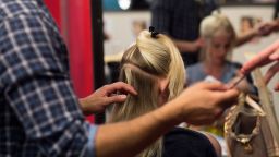 Caption:Coiffeur Fis Uka styles the hair of Veronica at Udo Walz' salon in Berlin on July 10, 2013. AFP PHOTO / JOHANNES EISELE (Photo credit should read JOHANNES EISELE/AFP/Getty Images)
