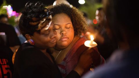 Chasyn Carter, right, embraces Candice Ancrum during a candlelight vigil outside North Charleston's City Hall on Wednesday, April 8.
