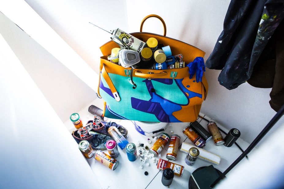 This limited-edition spray-painted Birkin full of old cans is hidden behind one of the panels. 
