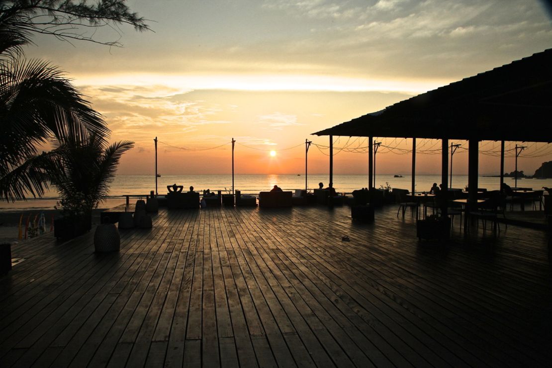 Cede Resort's restaurant and bar has white sofas and wicker furniture on a timber deck looking over the ocean.