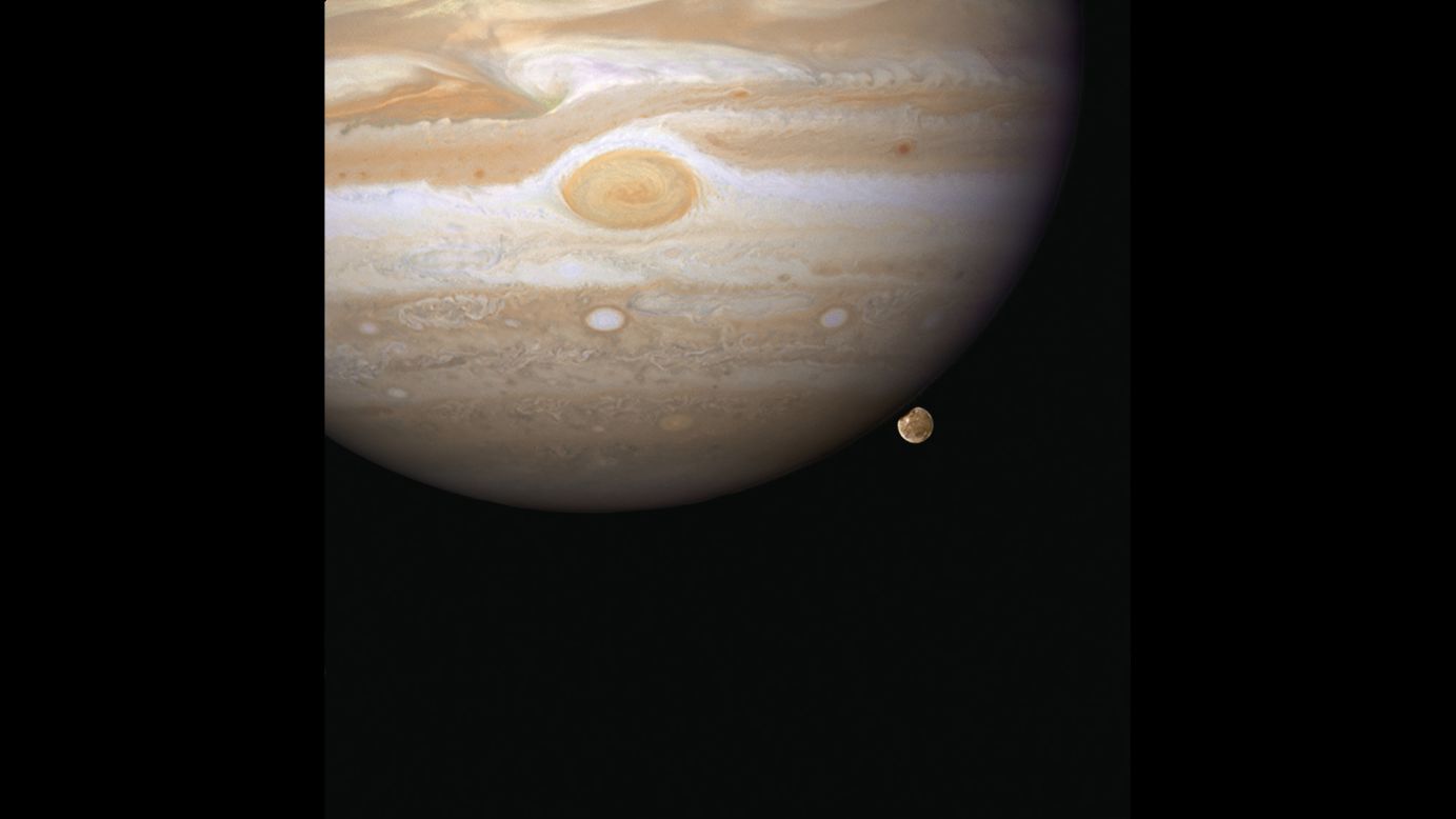 Hubble snapped this image in 2007 of Ganymede appearing to peek out from beneath Jupiter. Ganymede is the largest moon in our solar system and it's even bigger than Mercury.
