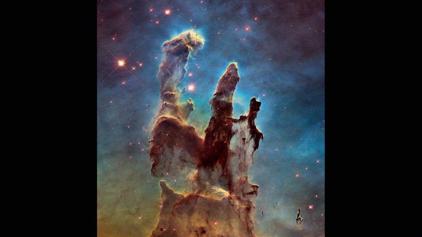 Astronomers combined several Hubble images taken in 2014 to create an upgraded view of the Hubble's iconic 1995 "Pillars of Creation" image. The new image shows a wider view of the pillars, which stretch about 5 light-years high. The pillars are part of a small region of the Eagle Nebula, which is about 6,500 light years from Earth.