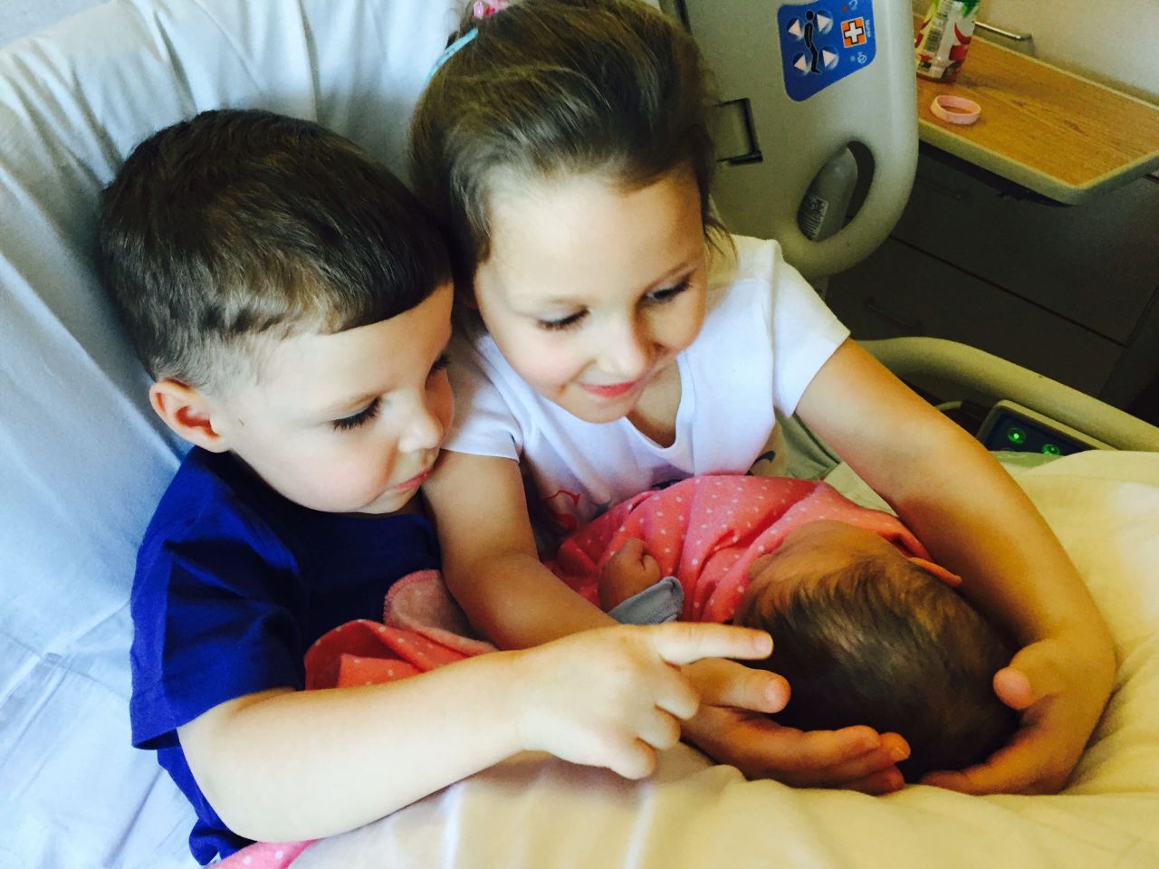 "This being my third cesarean delivery, they were adequately prepped on being gentle with both Mommy and baby once baby arrived. This picture was taken as they sat in my hospital bed, pillows all propped up, proudly sporting their big brother and big sister shirts." -- <a href="http://ireport.cnn.com/docs/DOC-1231814">Robyn Augustine</a>, Monroe, Connecticut 