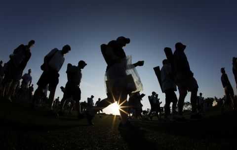 APRIL 9 - GEORGIA, UNITED STATES: Spectators walk along the first fairway before the first round of the revered Masters golf tournament at Augusta, which begins today.