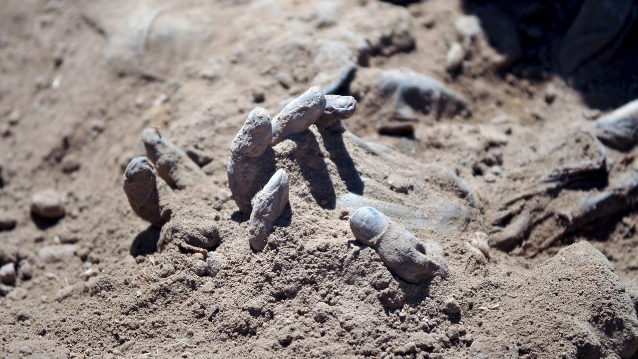 A hand is seen Monday, April 6, as forensic teams recover dead bodies from a mass grave in Tikrit, Iraq. <a href="http://www.cnn.com/2014/06/13/world/gallery/iraq-under-siege/index.html" target="_blank">Tikrit was recently retaken</a> by Iraqi forces and Shiite militiamen. It had been under control of the ISIS militant group since June.