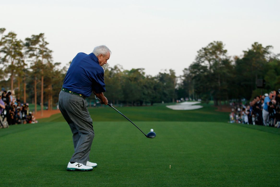 Four-time Masters winner Arnold Palmer, one of three honorary starters, hits his ceremonial tee shot at the first hole. 