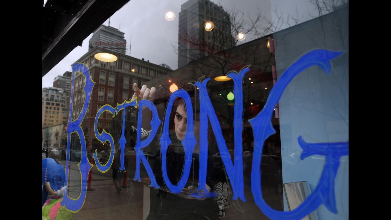 Camille Lerner puts the finishing touches on a window painting at Sugar Heaven, a candy store in Boston, on Wednesday, April 8. She painted the window after Dzhokhar Tsarnaev, a suspect in <a href="http://www.cnn.com/2013/04/21/us/gallery/week-in-boston/index.html" target="_blank">the Boston Marathon bombings</a>, was found guilty on 30 counts. The candy store is across from the finish line where the bombings happened in April 2013.
