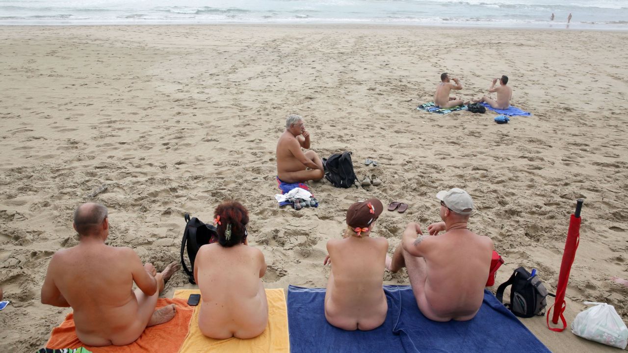 Naturists relax Saturday, Aprll 4, at Mpenjati beach in South Africa.