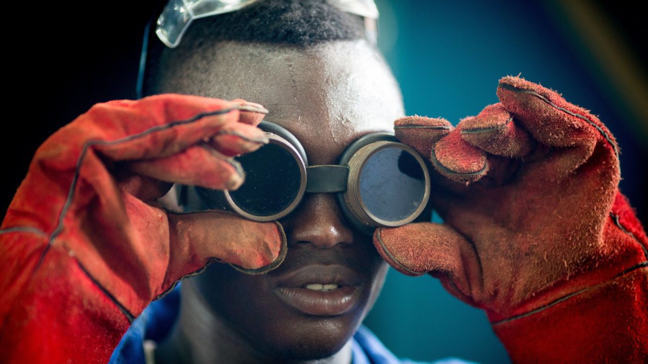 An apprentice puts on his welding glasses at a training facility in Accra, Ghana, on Wednesday, April 8.