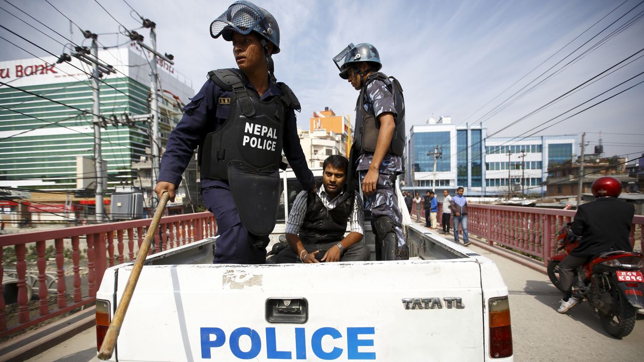 Riot police in Kathmandu, Nepal, detain a protester Tuesday, April 7, during a nationwide strike demanding that the country's first constitution be drafted with the consensus of all political parties. At the heart of the dispute is disagreement over creating new provinces based on ethnicity.