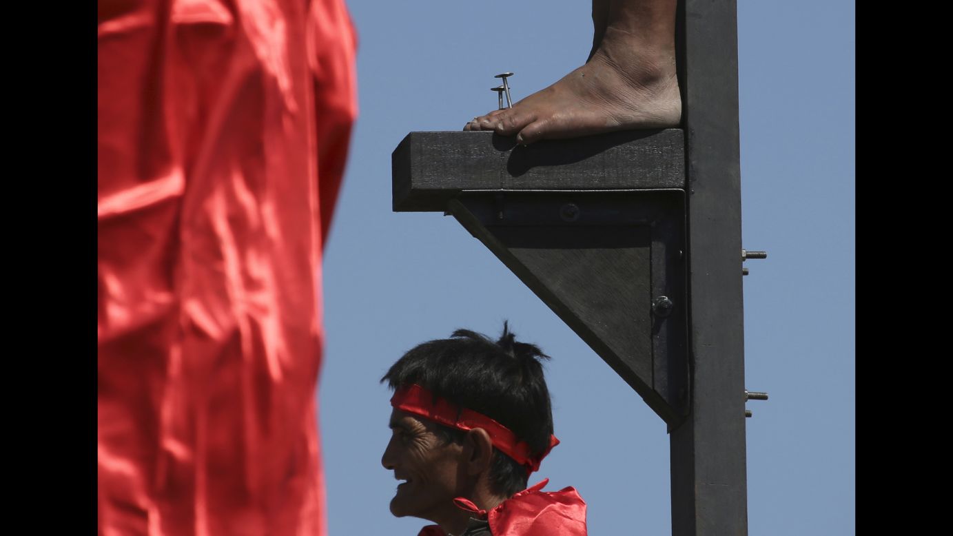 The feet of a penitent is nailed to a wooden cross during Good Friday rituals in Cutud, Philippines, on April 3. Several Filipino devotees had themselves nailed to crosses to remember Jesus Christ's suffering and death.