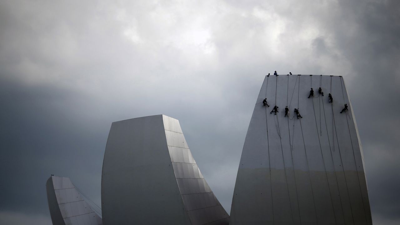 Cleaners wash the facade of the ArtScience Museum in Singapore on Wednesday, April 8.