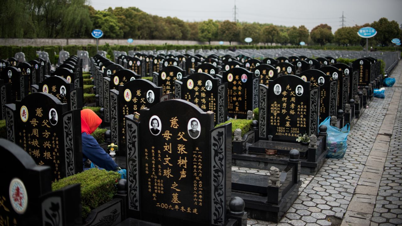 A worker cleans graves at a public cemetery in Shanghai, China, during the annual "Qingming" festival, or Tomb Sweeping Day, on Monday, April 6. During "Qingming," Chinese traditionally tend to the graves of their departed loved ones.