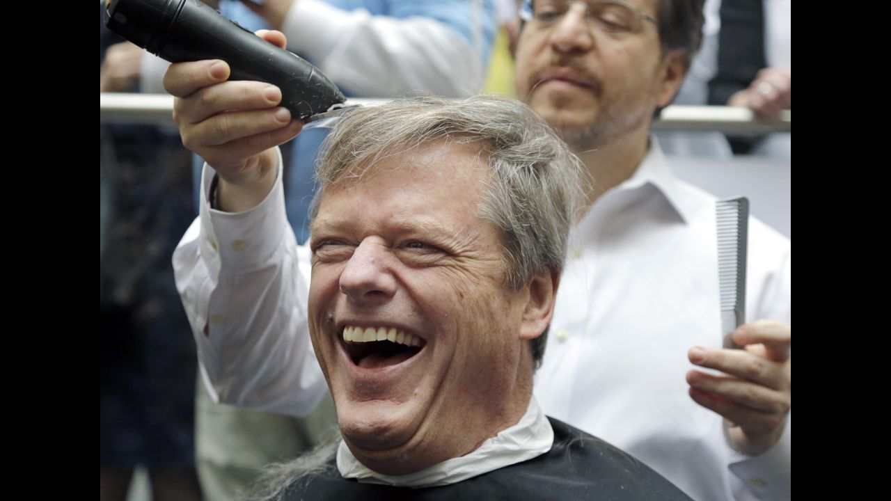 Massachusetts Gov. Charlie Baker gets a buzz cut during a fundraising drive in Quincy, Massachusetts, on Tuesday, April 7. Baker joined more than 500 employees at Granite Telecommunications who shaved their heads to raise more than $3.5 million for cancer research.