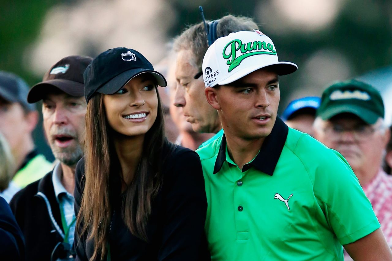 American Rickie Fowler, who tied for fifth at last year's Masters, waits for his tee-off with girlfriend Alexis Randock. The Ryder Cup player ended the opening day tied for 41st on 73 with Woods.