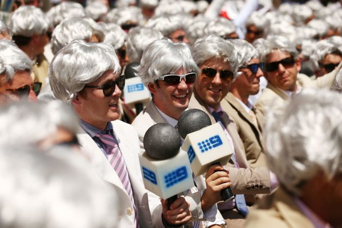 Many fans impersonates Richie Benaud by wearing his iconic white hair wig and holding fake microphones in the cricket match between Australia and England on January 4, 2014 in Sydney, Australia.