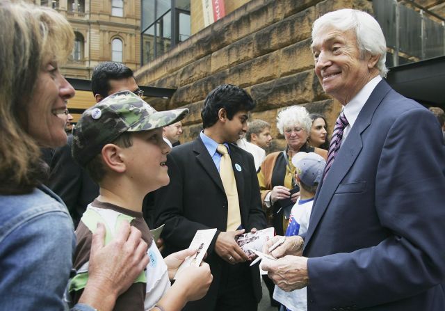 Richie Benaud signs autographs for fans during outside the Museum of Sydney on November 8, 2006, prior to cricket match between Australia and England.