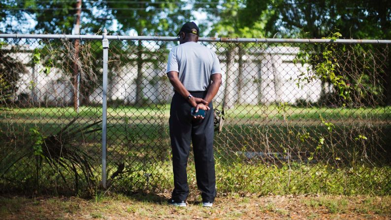 Joe Gilliard looks over a fence April 9, 2015, at the spot where Walter Scott was shot and killed by a police officer April 4 in North Charleston, South Carolina. The officer, <a href="index.php?page=&url=http%3A%2F%2Fwww.cnn.com%2F2015%2F04%2F08%2Fus%2Fsouth-carolina-michael-slager%2Findex.html" target="_blank">Michael Slager</a>, has been charged with murder in the fatal shooting of<a href="index.php?page=&url=http%3A%2F%2Fwww.cnn.com%2F2015%2F04%2F08%2Fus%2Fsouth-carolina-who-was-walter-scott%2Findex.html" target="_blank"> Scott</a>, an unarmed 50-year-old. Video captured by a bystander showed Slager shooting Scott as he ran away.