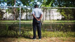 Joe Gilliard looks over a fence on Thursday, April 9, at the spot where Walter Scott was shot and killed by a North Charleston police officer.