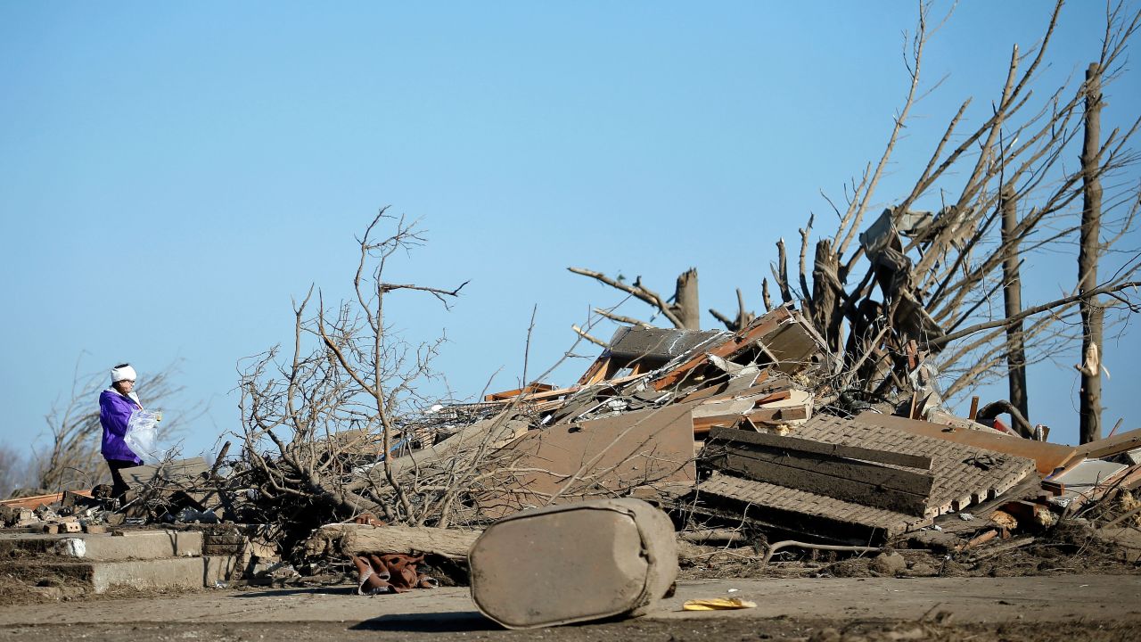 Candy Trudell looks through the wreckage of her home in Rochelle on April 10.