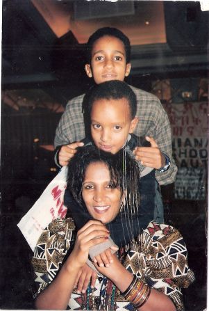 "On one hand I was very successful with my beauty work... at home I was frustrated because of my son's autism. I didn't know what to do. I didn't know how to help my child. I wasn't able to communicate with my own son," recalls Yenus, pictured with her two sons, Jojo in the middle and older brother, Bilal. 
