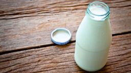 Fresh Milk on Glasses Bottle, Dairy Produce Concept of Breakfast on Wood Table, Country Rustic Style.