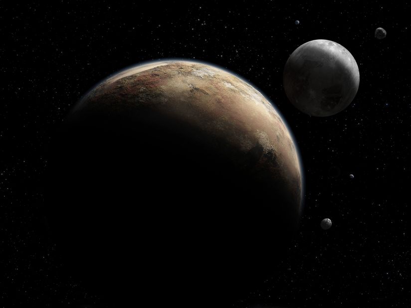 An artist's concept shows Pluto and its moons. Pluto's moon Charon has cracks that suggest it once had underground water. 