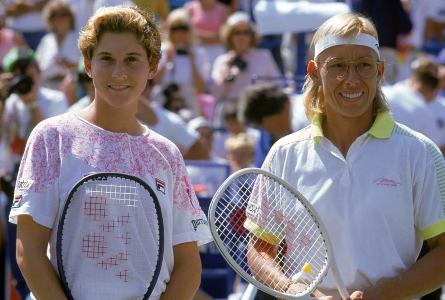 A baby-faced Monica Seles poses with Martina Navratilova after winning the 1991 U.S. Open.