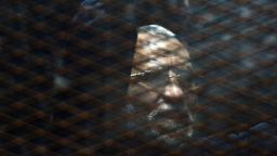 Caption:Egyptian Muslim Brotherhood leader Mohamed Badie stands behind bars during his trial at the non-commissioned police officers institute in the capital Cairo on 28 February, 2015. The court sentenced Badie to life imprisonment over the killing of protesters who stormed the group's Cairo headquarters in 2013. Three co-defendants of Badie were sentenced to death in the same trial. AFP PHOTO/ MOHAMED EL-SHAHED (Photo credit should read MOHAMED EL-SHAHED/AFP/Getty Images)