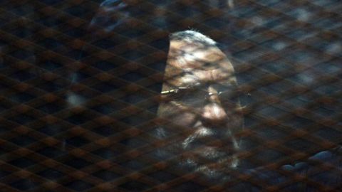 The Muslim Brotherhood's Mohamed Badie appears behind bars during a trial last year in Cairo.